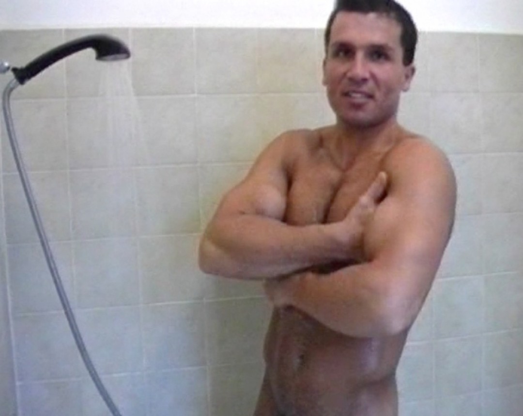 Muscled guy under shower