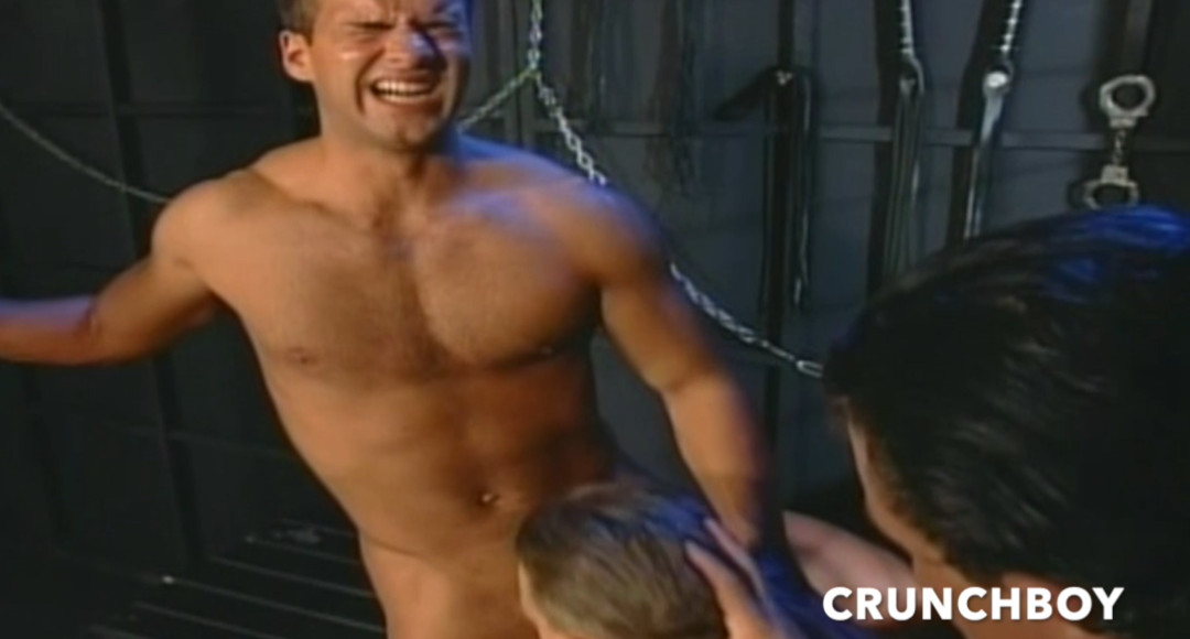 Three muscular guys have BDSM sex in a dungeon in fetish clothes